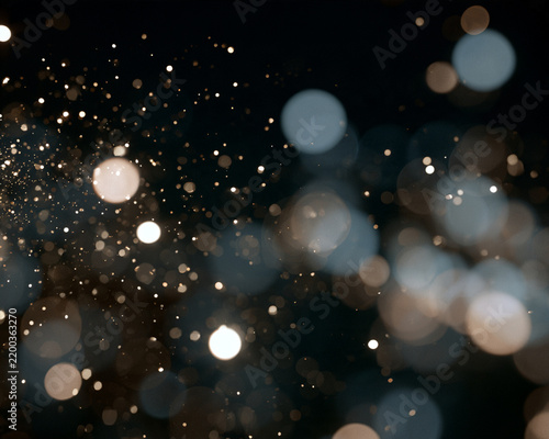 Soft bokeh lights create a dreamy depth with scattered glowing orbs. The out-of-focus circular shapes vary in intensity and size with warm golden and cool blue tones.