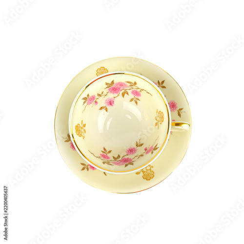 Elegant vintage porcelain teacup and saucer with pink floral design and gold rim, top view isolated on white background, square orientation with generous copy space.