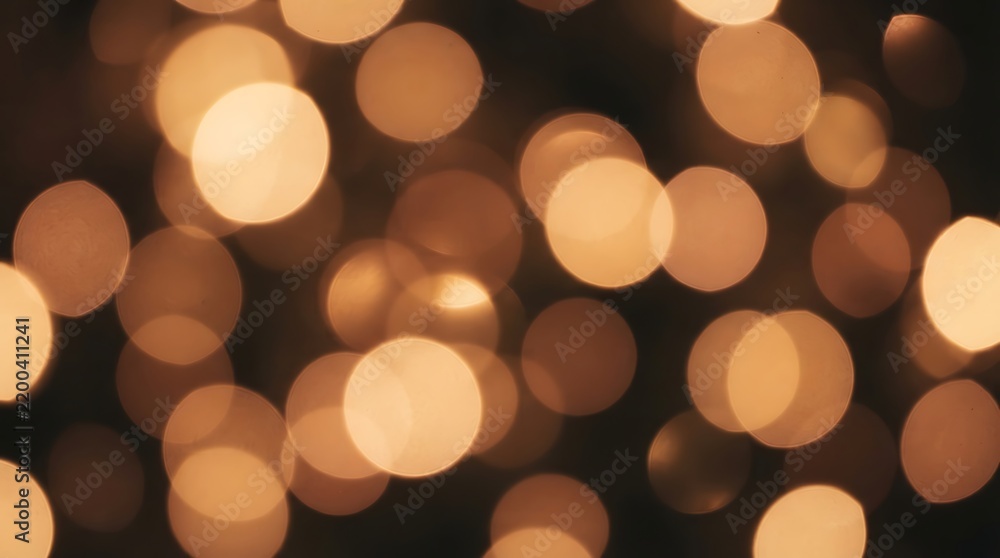 Fototapeta premium Abstract warm bokeh light background with soft glowing circles for design