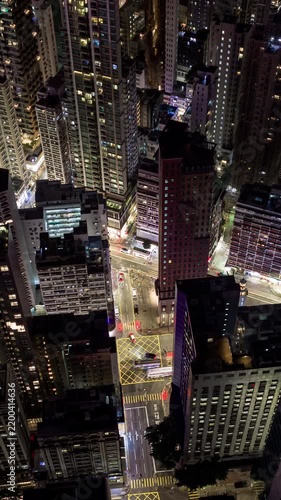 night time illumination flight over hong kong city downtown traffic street crossroad aerial vertical panorama 4k timelapse  