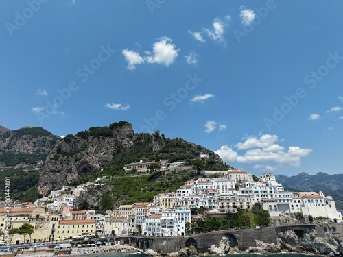 aerial view of Amalfi Harbour and beach front pleasure boats and yacht parked in the blue water of the Tyrrhenian Sea part of the larger Mediterranean Sea