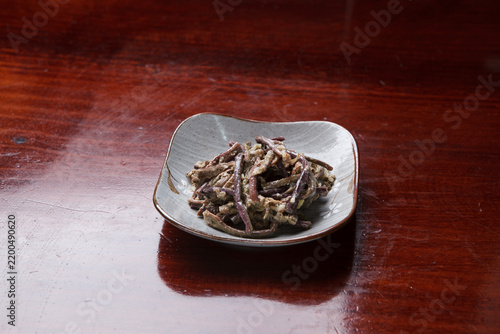 Korean seasoned fernbrake namul side dish on small ceramic plate