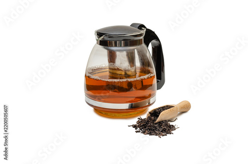 Glass Teapot with Freshly Brewed Black Tea and Dry Loose Tea Leaves