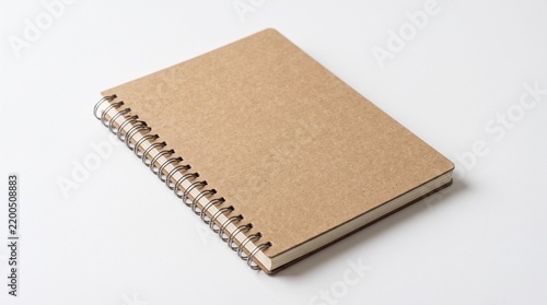 Closed Spiral Notebook with Brown Kraft Cardboard Cover on White Background