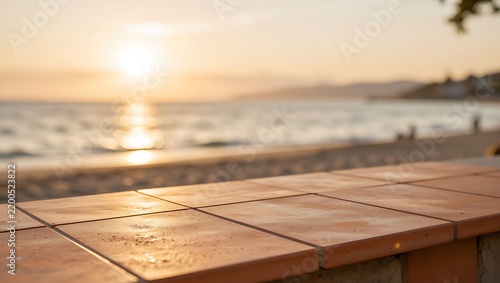 A terracotta tile surface overlooks a serene beach at sunset with gentle waves.