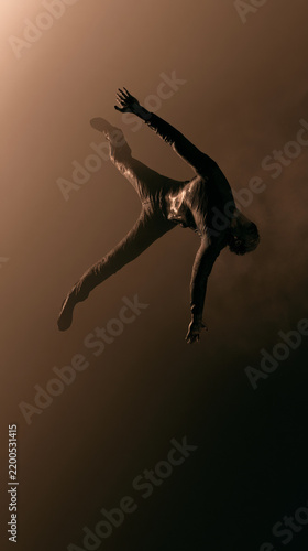Minimalist lone person stretching from low angle with moody low key lighting