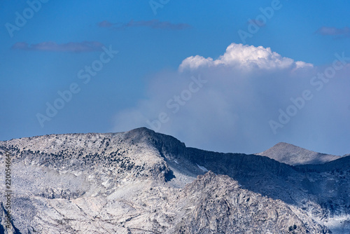 Smoke From A Distant Wildfire Rises Over A Sierra Nevada Mountain Ridge