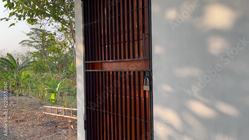 Locked Iron Gate of Private Property with Padlock and Outdoor Landscape