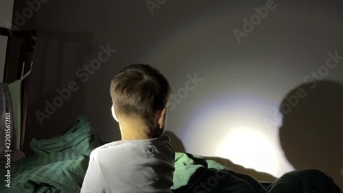 Toddler watching his shadow on a bedroom wall