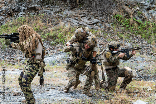 Fotografie Military training exercise takes place in rocky terrain with soldiers practicing