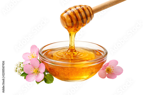 Fresh sweet honey pouring from wooden stick with floral blossoms isolated on a transparent background