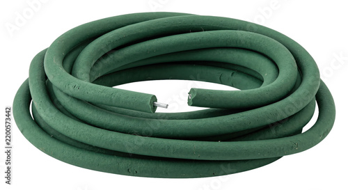 Obraz na plátně Coiled green garden hose with a textured surface and exposed metal core on a cle