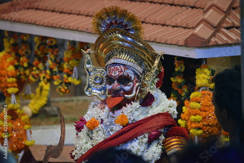 Fotografie Traditional Theyyam performer in elaborate headdress and floral garlands