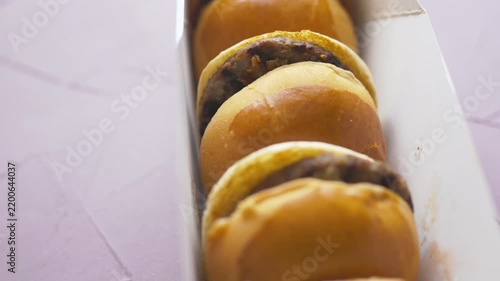 mini burgers or sliders served on a stylish wooden board