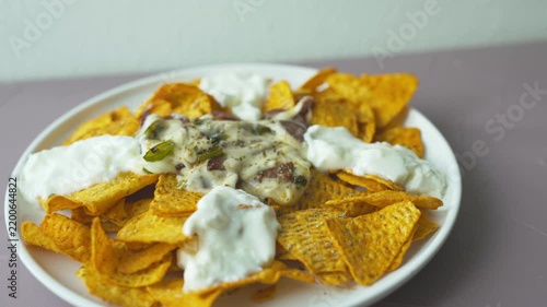 Loaded nachos with melted mozzarella cheese and tender beef close-up