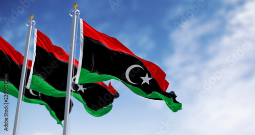 Картината върху платно National flags of Libya waving on a clear day.
