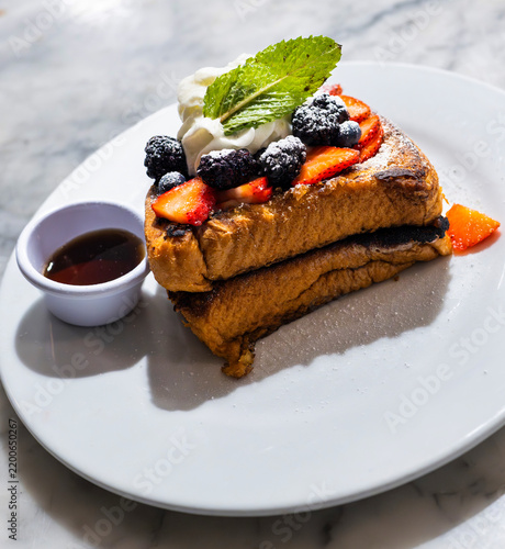 French Toast with Fresh Berries, Whipped Cream and Maple Syrup