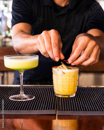 Bartender Preparing Two Cocktails Behind a Bar