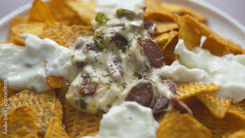 Loaded nachos with melted mozzarella cheese and tender beef close-up