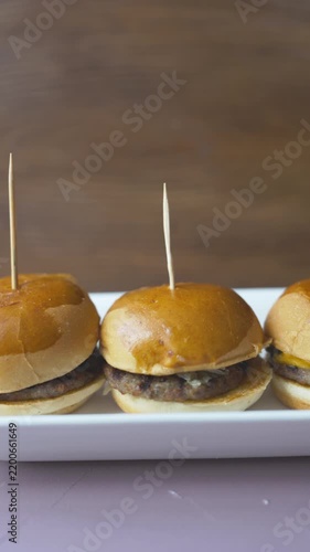 mini burgers or sliders served on a stylish wooden board