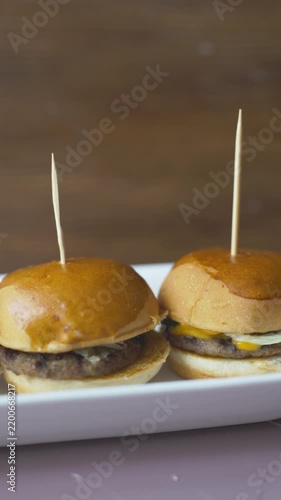 mini burgers or sliders served on a stylish wooden board