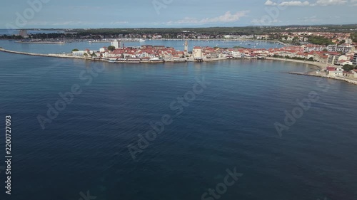 Aerial view of historic Umag old town peninsula coastline and breakwater in Istria Croatia
