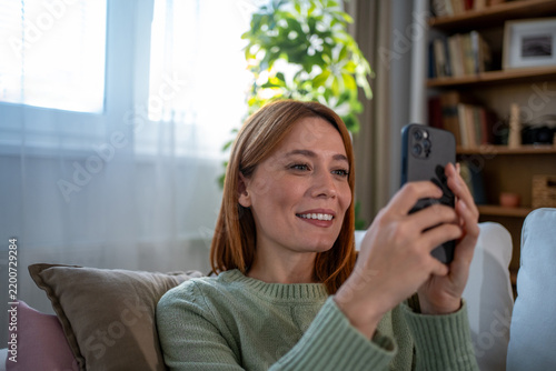 Woman smiling while using smartphone for video call