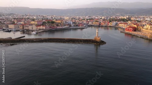  View of Chania with the amazing lighthouse, mosque, venetian shipyards, Crete, Greece.Waves crashing on lighthouse, Beautiful Greece and best scenic places - panorama