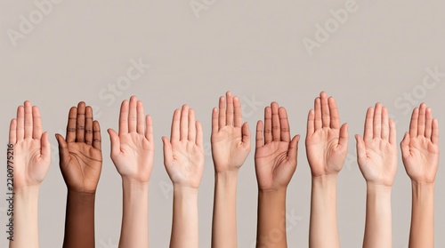 Diverse human hands of different skin tones raised up on beige background