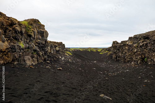 Volcanic landscape with rugged lava fields, black sand and poor local vegetation, and the dramatic scenery of the Reykjanes Peninsula, Iceland, next to Bridge Between Continents (Brú Milli Heimsálfa).