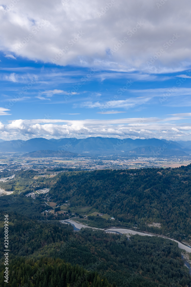 Fototapeta premium Aerial Landscape of Chilliwack BC Valley With Mountains, Forests and Dramatic Cloudy Sky
