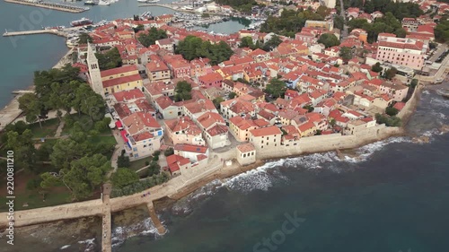 Aerial view of historic Novigrad old town stone fortifications and bell tower in Istria Croatia