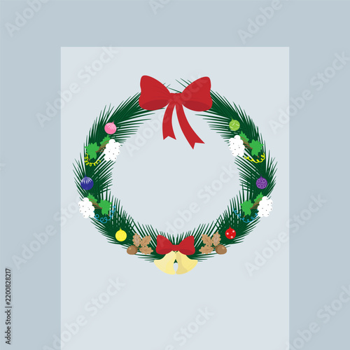 A Christmas wreath hangs against a gray background. The concept of the new year and Christmas