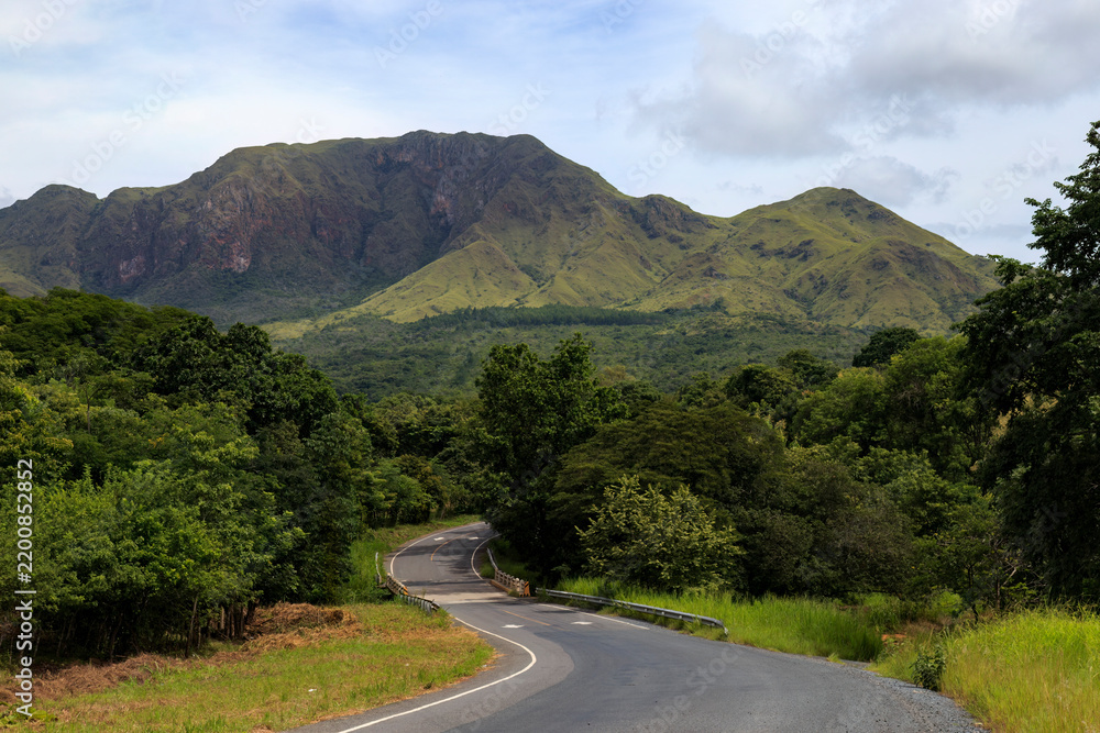 Obraz premium Winding road leading towards Cerro Guacamaya mountain in Cocle, Panama, tropical landscape and nature reserve concept