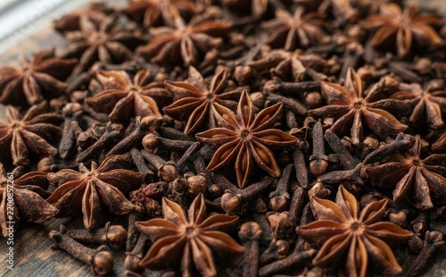 Star anise and cloves spices background top view, aromatic winter seasoning for cooking, baking and festive holiday recipes, gourmet food ingredient photography