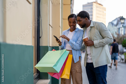 Black couple shopping online using smartphone