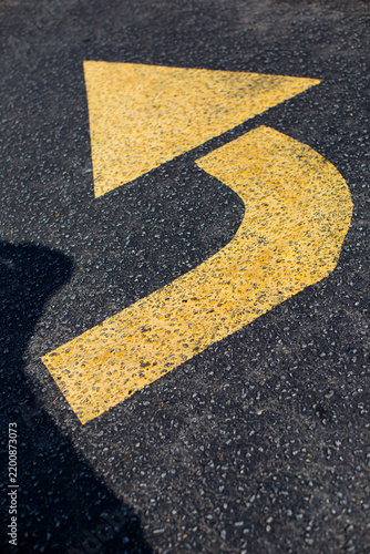 yellow arrow on asphalt