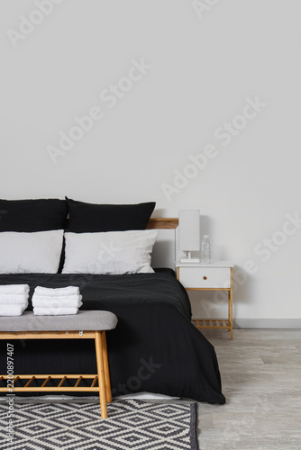 Hospitality and hotel room comfort, clean bedroom interior with black bedding...