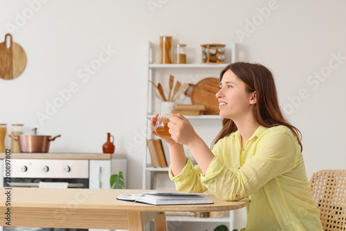 Mindfulness and mental health, young woman relaxing with a cup of tea and a b...
