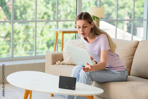 Internet connection problem, woman frustrated with slow wifi router and lapto...