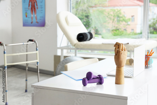 Physical therapy and rehabilitation, medical office desk with dumbbells and w...
