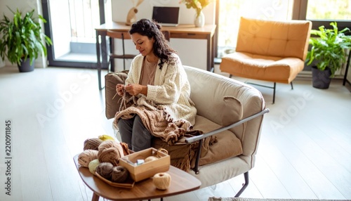 Woman Knitting with Yarn on Sofa in Cozy Living Room