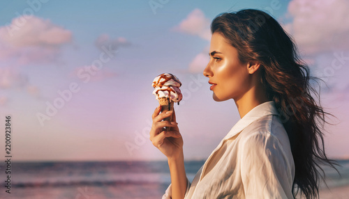 Beautiful young woman holding delicious melting ice cream cone against a vibrant sunset sky background scene