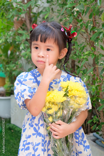 Young Asian Girl Holding Yellow Chrysanthemum Flowers Outdoors