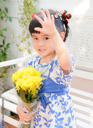 Young Asian Girl Holding Yellow Chrysanthemum Flowers Outdoors