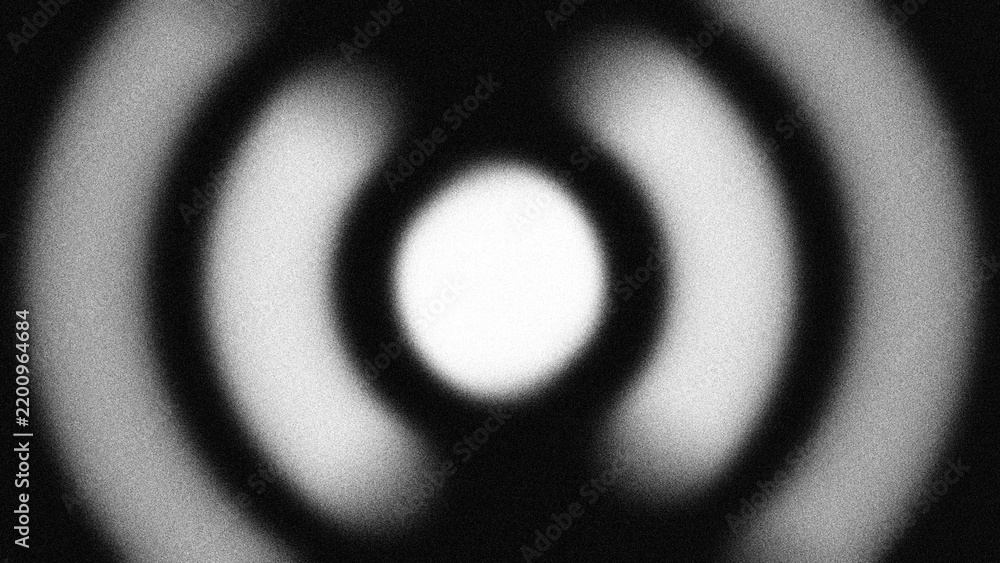 Fototapeta premium Monochromatic concentric rings with a grainy blur texture create a hypnotic radial effect, perfect for abstract motion backgrounds