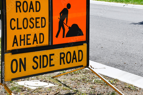 road work and road closed sign on suburban road