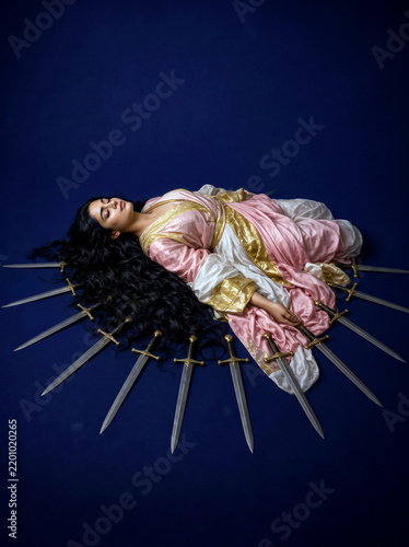 Bild auf Leinwand A dramatic conceptual portrayal of the Ten of Swords tarot card depicts a woman