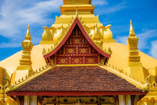 Golden buddhist temple with Intricate lanna architecture under a blue sky