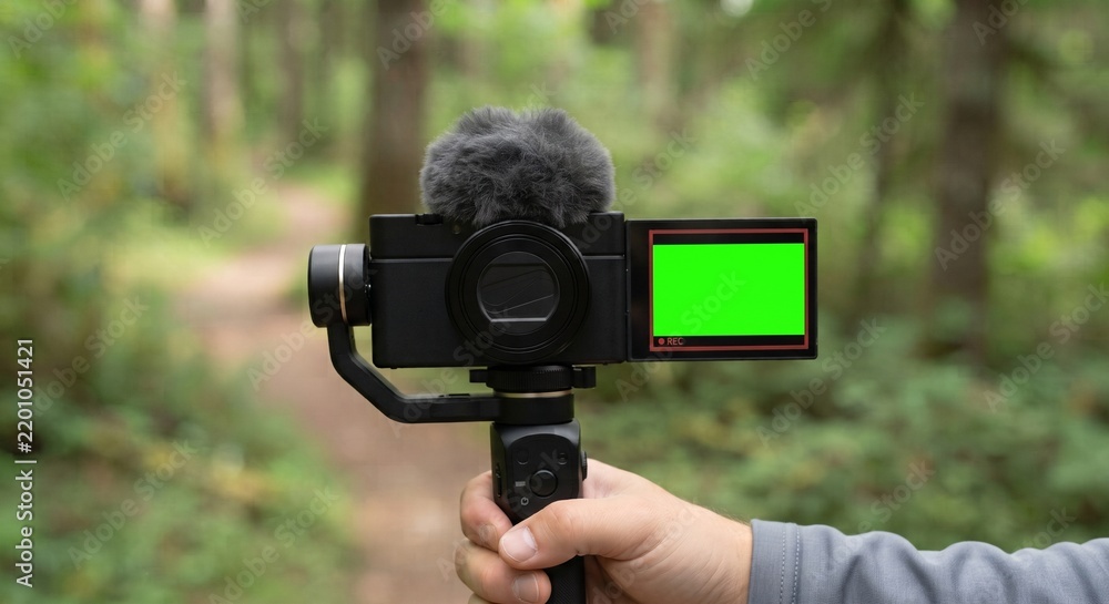 Fototapeta premium Handheld Vlogging Camera Rig with Green Screen Display in Forest